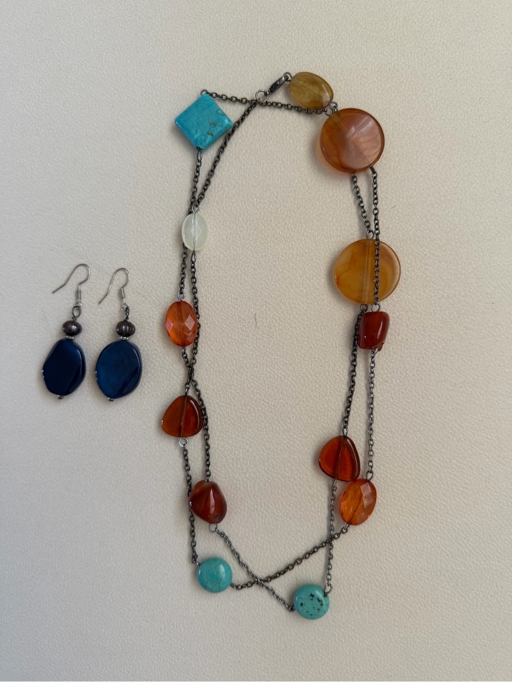 Vintage- style multi strand necklace with matching blue stone earrings.
